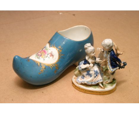 A ceramic blue glazed and hand painted clog and a 20th century Porcelain figure group. 

