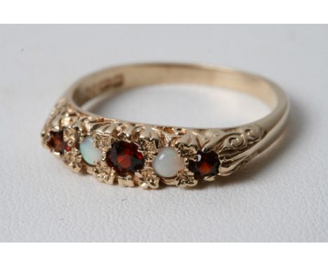 A 9ct yellow gold ring inset with garnets and opals 