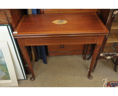 A Georgian inlaid card table on turned and cabriole legs. 