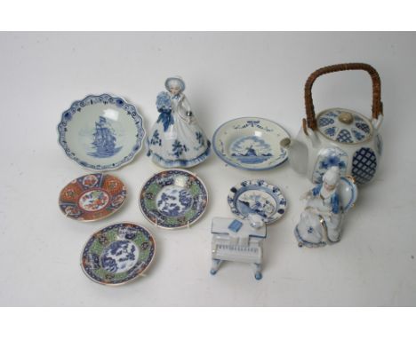 A collection of blue and white ceramic items including a musical figurine, some Delft and some Chinese.