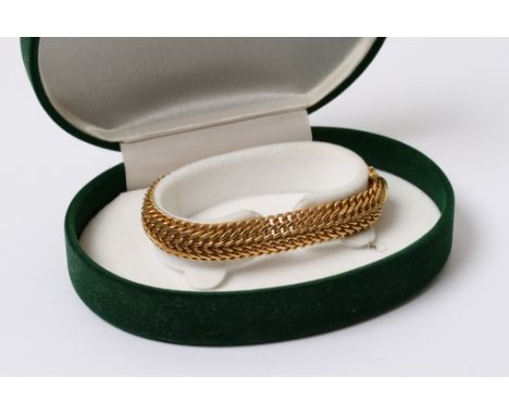 A 9ct gold bangle in a green fitted box
