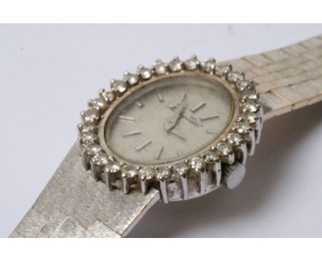 A lady's 18ct white gold Tissot watch "Mathey" with a diamond studied bezel , working order 