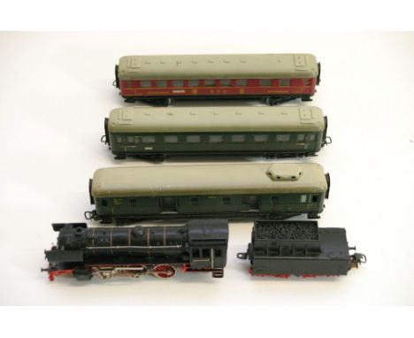 A collection of unboxed Marklin Railway items including an engine and tender and three railway coaches 