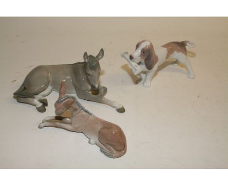A Lladro figure in the form of a dog, a donkey, and a foal