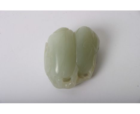 An oriental carved jade of a double fruit 