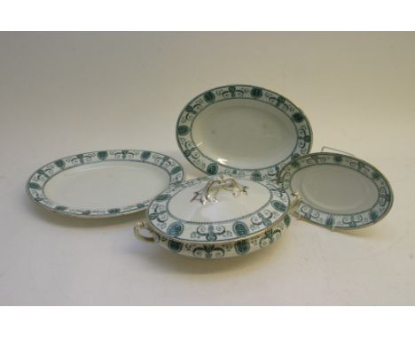 A late 19th Century ceramic dinner service with blue/green decoration on a white ground with gilt edging.