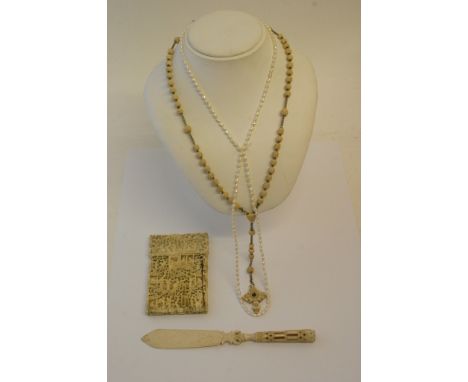 A carved ivory card case, bone letter opener, rosary and seed pearl necklace, all a/f