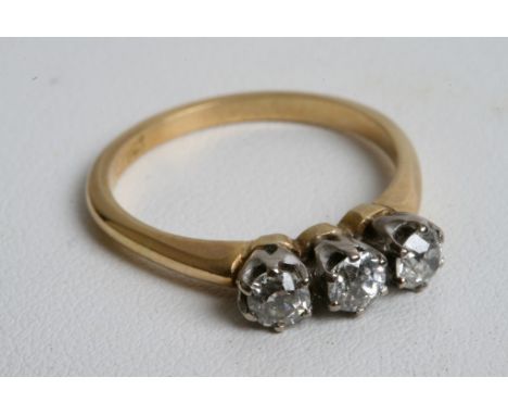 An 18ct gold ladies ring inset with three old cut diamonds. 