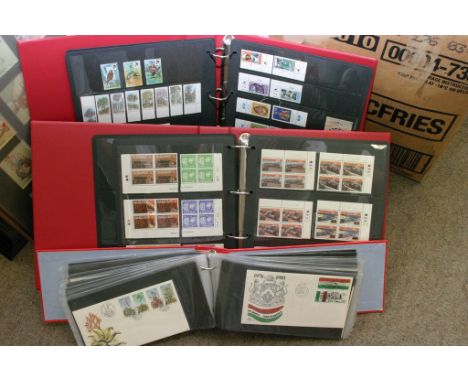 Three albums containing postage stamps from South Africa, Zimbabwe, Transkei etc. including mint stamps, miniature sheets, fi