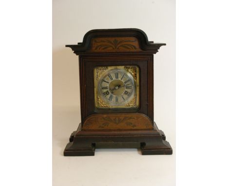 An inlaid Mahogany continental mantel clock.