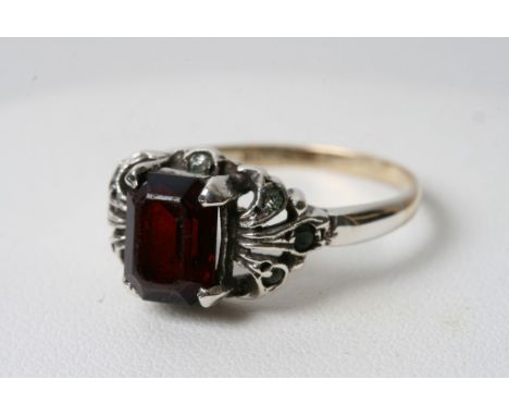 A 9ct gold and silver ring inset with a red stone 