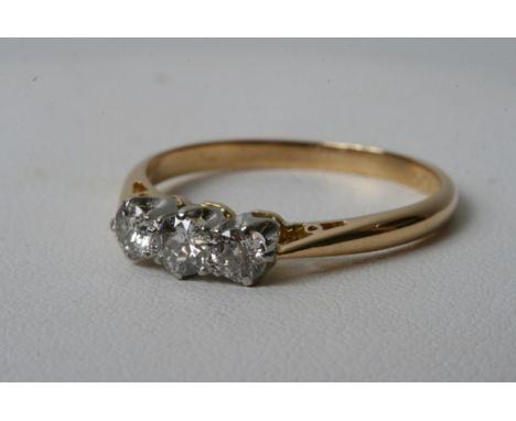 An 18ct yellow gold and platinum ring set with three diamonds 0.5ct approx 