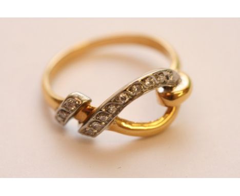 A ladies 18ct yellow gold ring of modern knot design and set with numerous small diamonds