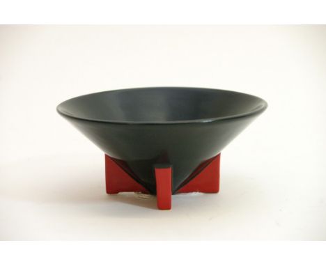 A rare Wilkinson Yoo Hoo type pattern circular dish, decorated in black with three red fin shaped legs of rocket form, attrib