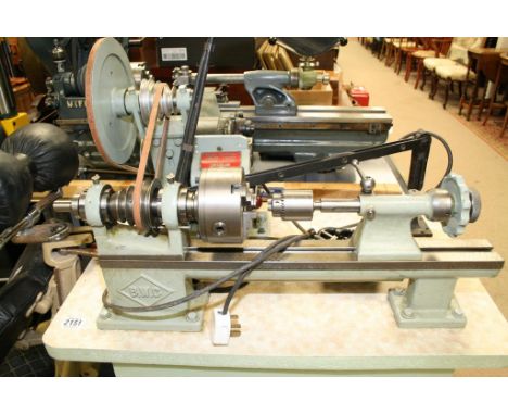 A 1940s B.W.C metal lathe on cabinet presented in good used cosmetic condition (untested) with a four step pulley arrangement