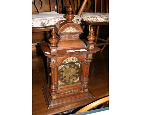 A good continental walnut cased mantle clock with metal mounted dial, pendulum and key