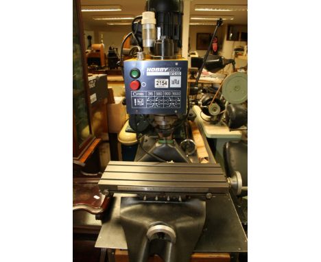 A Hobbymat BFE65 bench vertical milling machine, with adjustable bed, sold on cabinet appearing in good order