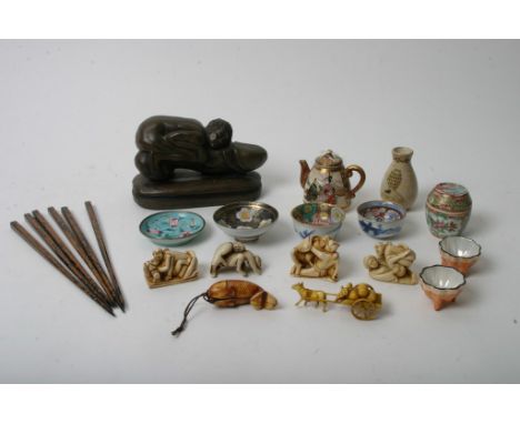 A collection of oriental items including a Satsuma teapot, okimomo erotic figures and odds