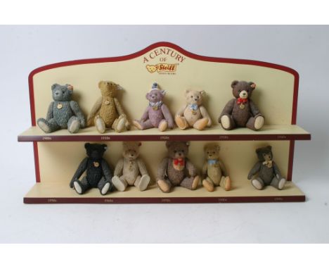 A collection of ten ceramic Steiff bear figures on original display stand. 