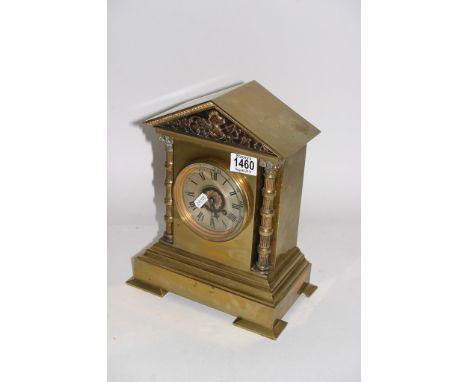 A 19th Century brass cased Mantel clock by Maple & Co, Paris, the dial having columns to either side and with knight's crest 