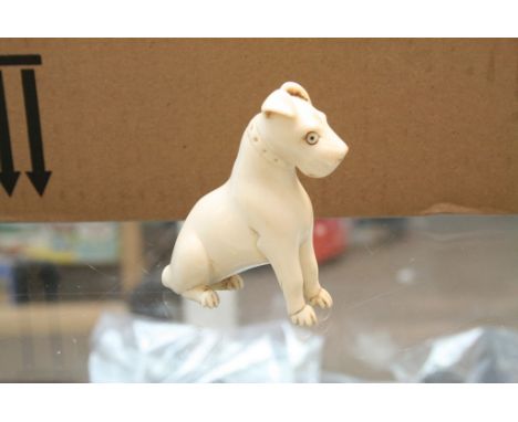 An ivory model of a seated dog