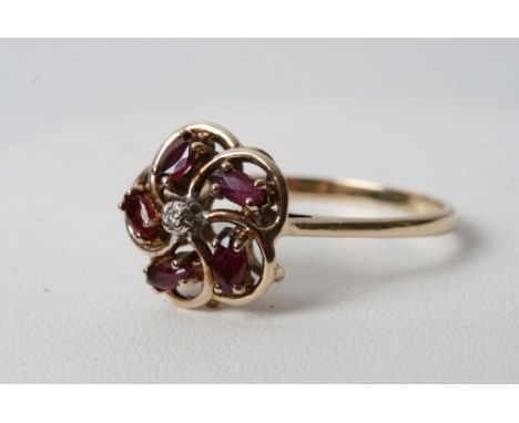 A 9ct gold diamond and ruby ring of foliage design 