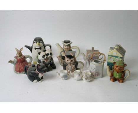 Three boxes of novelty teapots and various ceramic items.