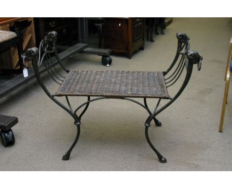 A reproduction garden bench having wicker seat, the frame surmounted by dog's head decoration.