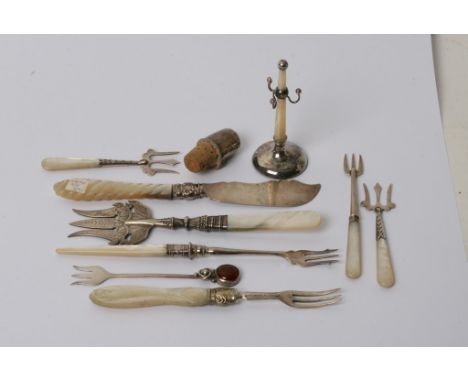 A small bag of silver and mother of pearl flatware