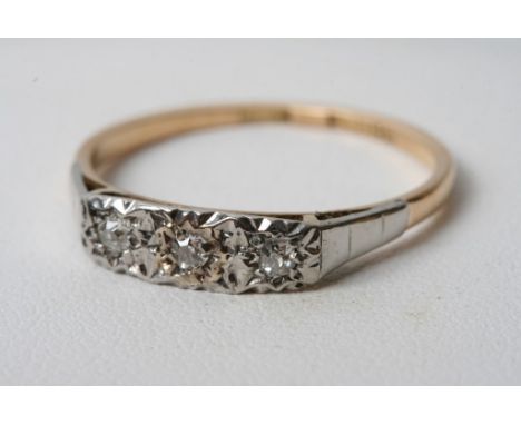 A yellow gold and platinum three stone diamond ring 