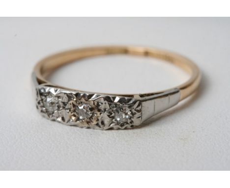 A yellow gold and platinum three stone diamond ring 