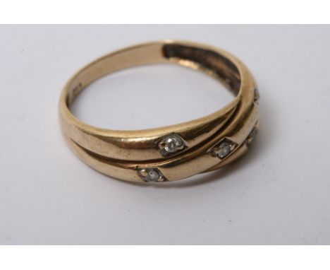 A 9ct gold crossover style ring inset with five diamonds