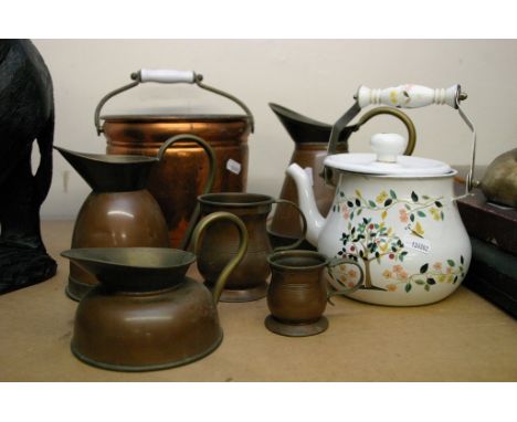 A collection of copper jugs plus a painted enamel jug.
