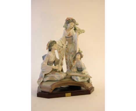 A large Lladro oriental figure group ' Oriental Music', modelled by Salvador Debon, numbered 53 of 5000, on wooden plinth. Ap