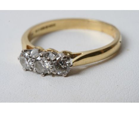 An 18ct gold three stone diamond ring 0.6ct approx 