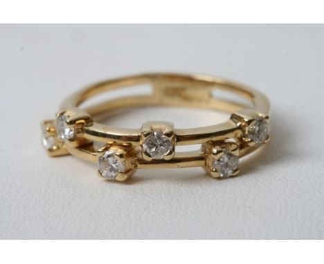 An 18ct gold ring set with two rows of three diamonds 