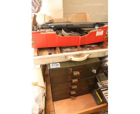 A collection of engineering tools comprising of metal lathe turning bits, a tray containing lathe and hand router pieces, and
