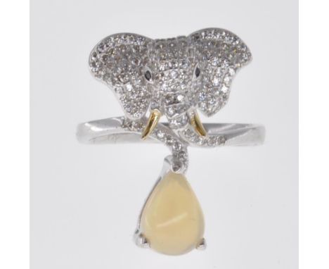 A stamped 925 silver ladies dress ring having an elephant to the top set with CZ's and an opaque stone within a claw setting 