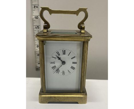 An antique brass cased carriage clock (untested). Damage to glass 