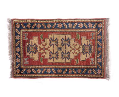 A Ziegler rug, PakistanWool and cotton of geometric pattern in bordeaux and blue shades(wear)85x60 cm