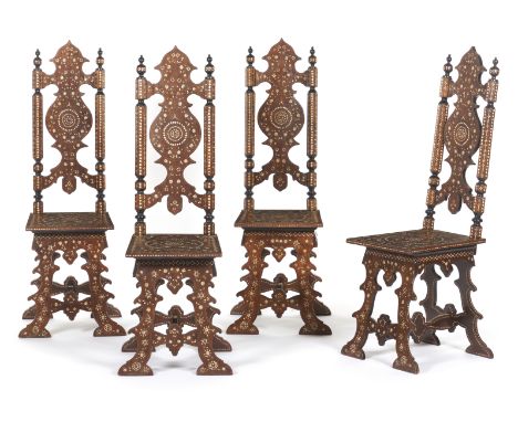 A set of four chairsExotic wood Geometric patterns and foliage motifs Inlaid ivory decoration Scalloped backs and legs Syria,