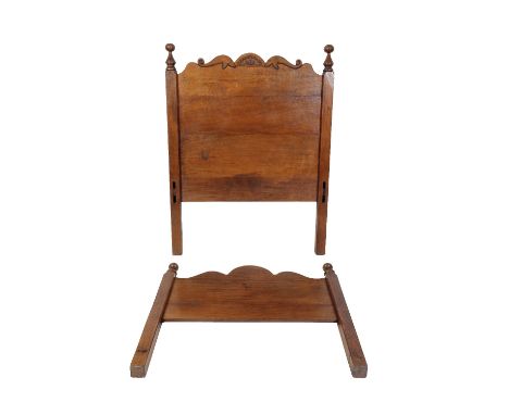 * NIGEL GRIFFITHS: A PAIR OF HANDMADE OAK SINGLE BEDS of Jacobean style, the headboards with a shaped and carved toprail with