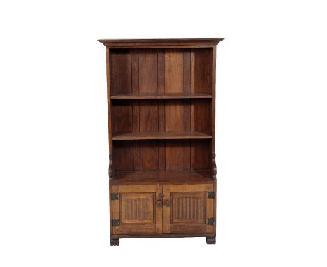 * NIGEL GRIFFITHS: A HANDMADE OAK BOOKCASE of Jacobean style, with two open shelves above twin cupboard doors below, 152cm hi