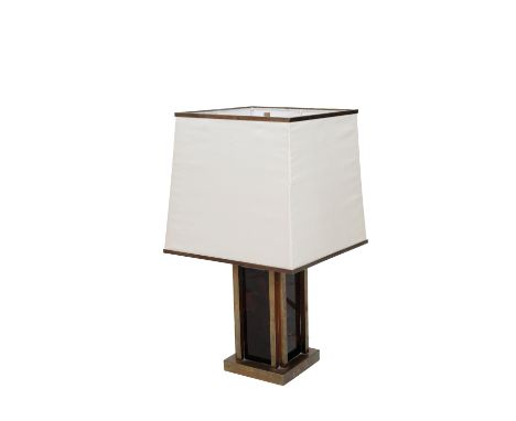   A CONTEMPORARY TABLE LAMP the brass frame surrounding a simulated amber body, with square shade