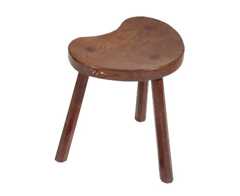   ROBERT THOMPSON OF KILBURN: A 'MOUSEMAN' OAK MILKING STOOL the adzed slightly dished top of kidney shape, with the signatur