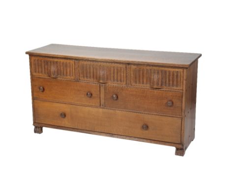 * NIGEL GRIFFITHS: A PAIR OF HANDMADE OAK LOW CHESTS OF DRAWERS of Jacobean style, each with three short hand carved drawers 