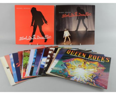 34 original 12 inch square record shop posters, featuring album covers of artists such as Queen, Janis Joplin, Pet Shop Boys,