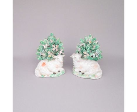 A pair of Derby porcelain recumbent sheep before bocage. Patch marks.Date: Circa 1765   Size: 10cm highCondition: Ears restor