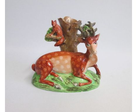 A Staffordshire Spill Holder with a Model of a recumbent Stag with a Fox sitting on a branch  Date: circa 1810      Size: 14c
