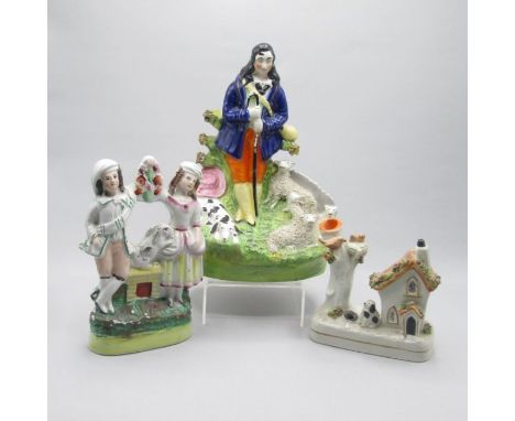 Three Staffordshire portrait figures, A shepherd and his dog and a flock of sheep, a boy and girl with a rabbit and a spill h